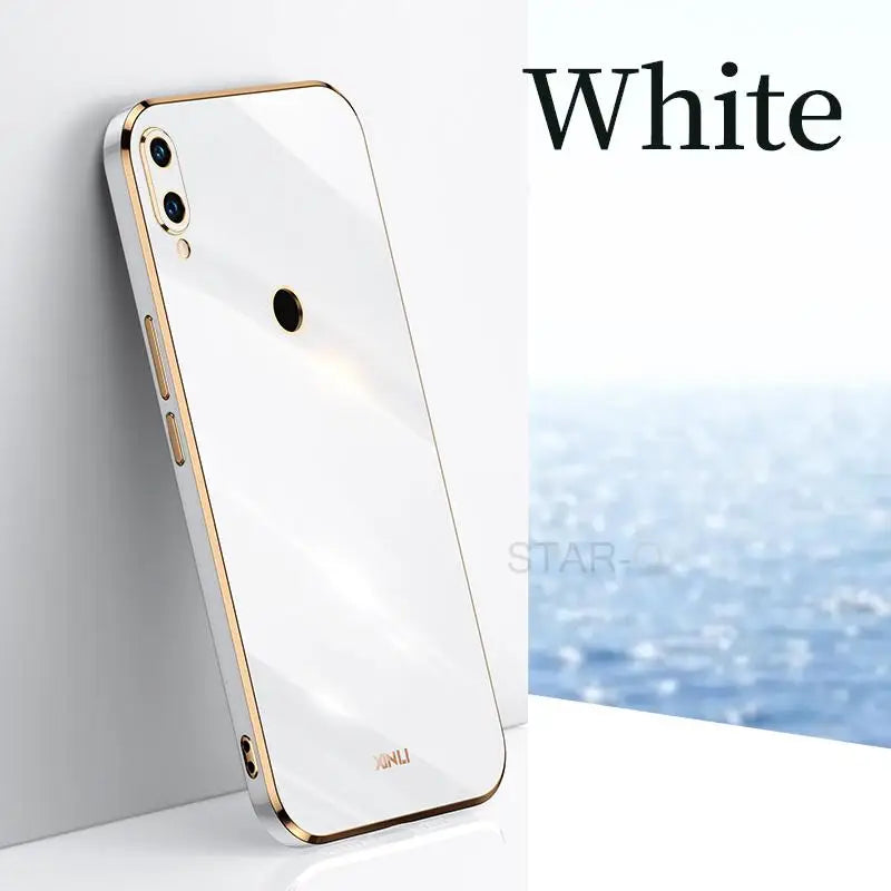 a white iphone with a gold case