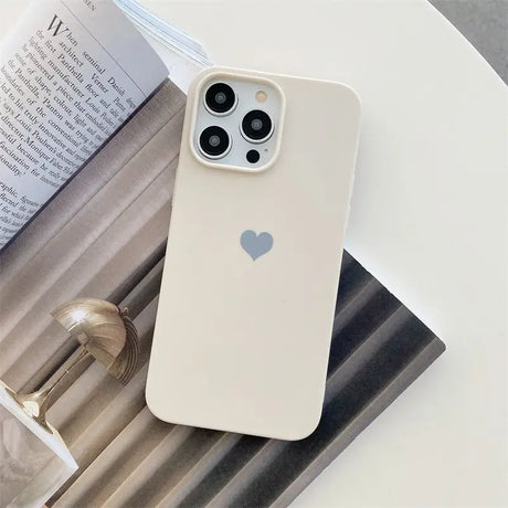 the iphone case is sitting on a table next to a book