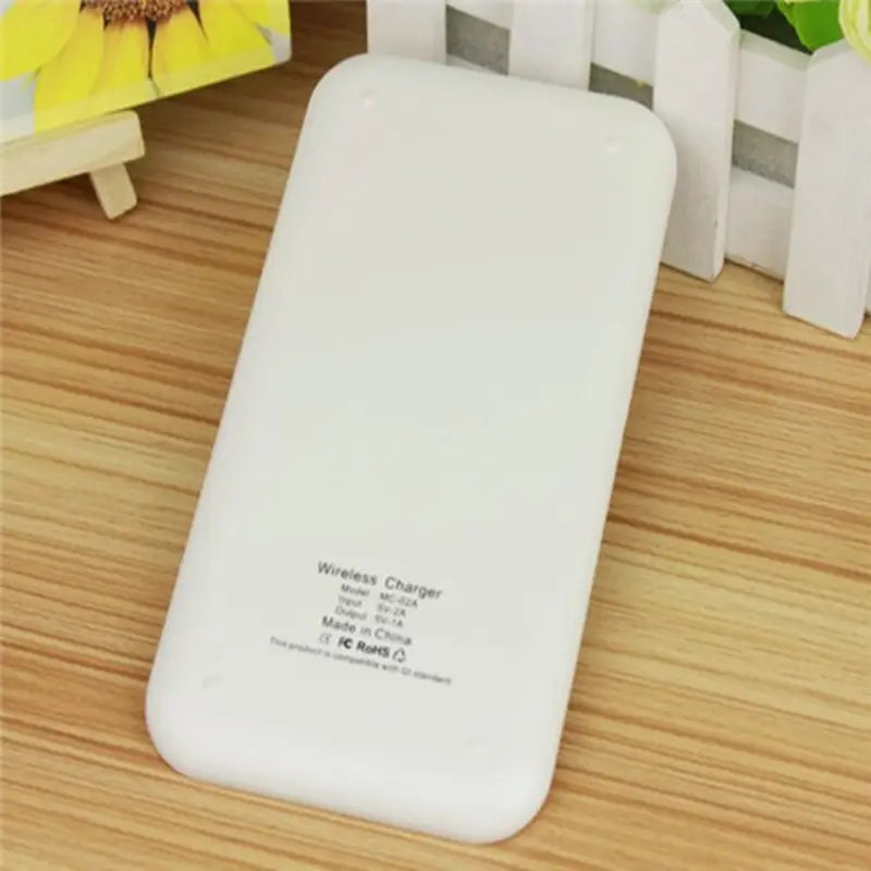 a white iphone case sitting on a wooden table