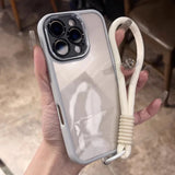 White iPhone case with a wrist strap.