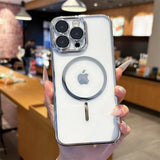 White iPhone with a clear, silver-edged case and a MagSafe ring.