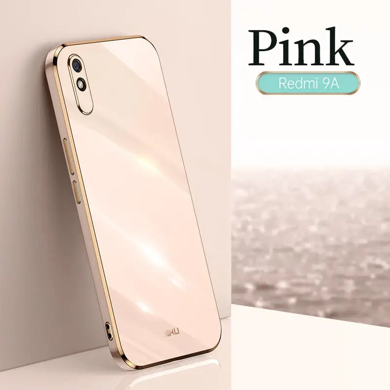 a white iphone with a gold case on it