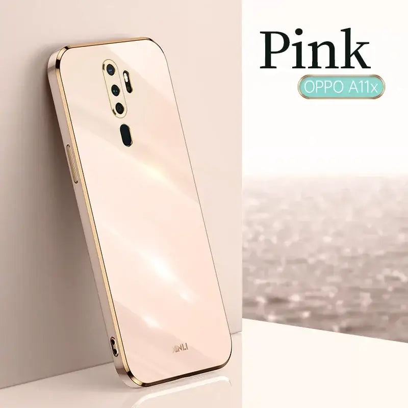 a white iphone with a gold case on it
