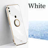 a white iphone with a gold ring on it