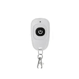 A white key chain with a black button