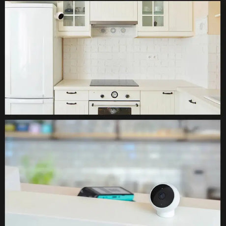 A white kitchen with a black and white camera