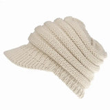 a white knitted hat with a knot on the side