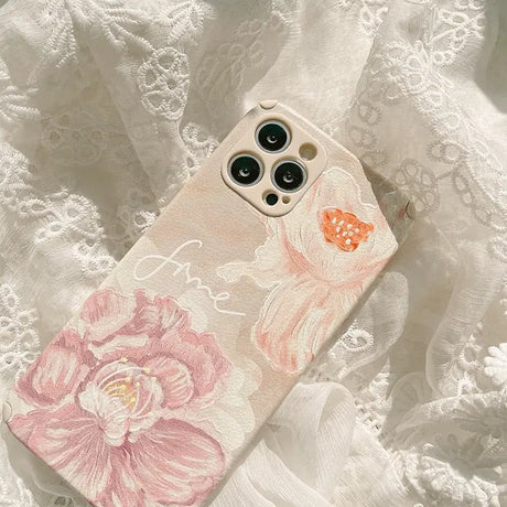 a white phone case with pink flowers on it