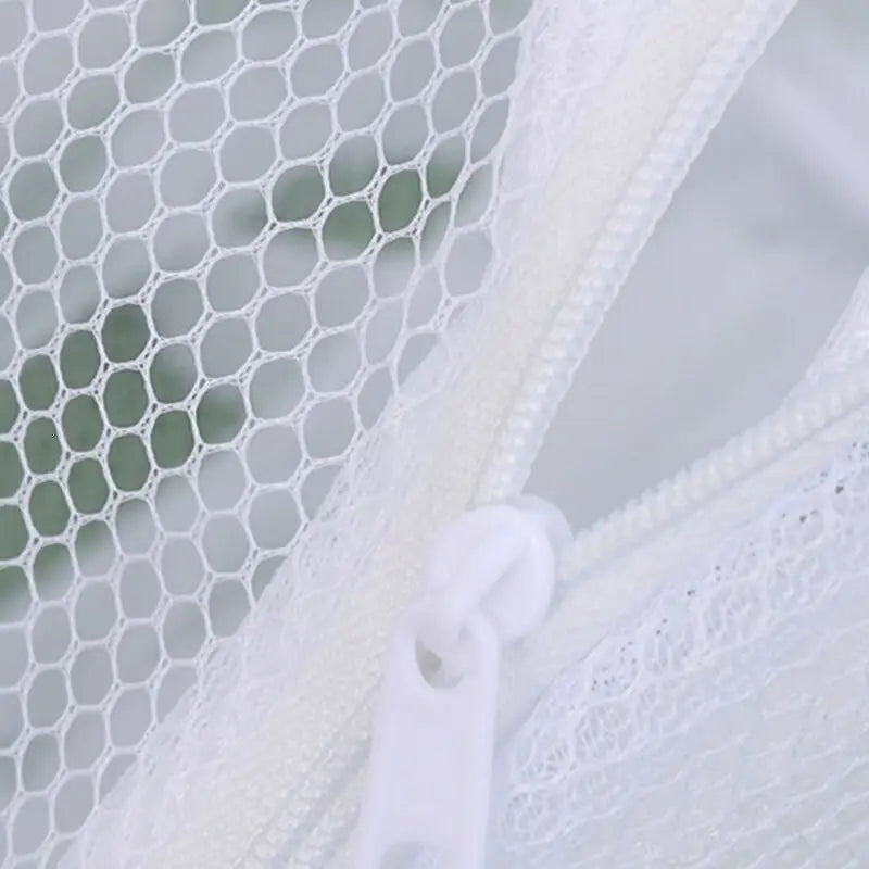 a white lace curtain with a white ribbon