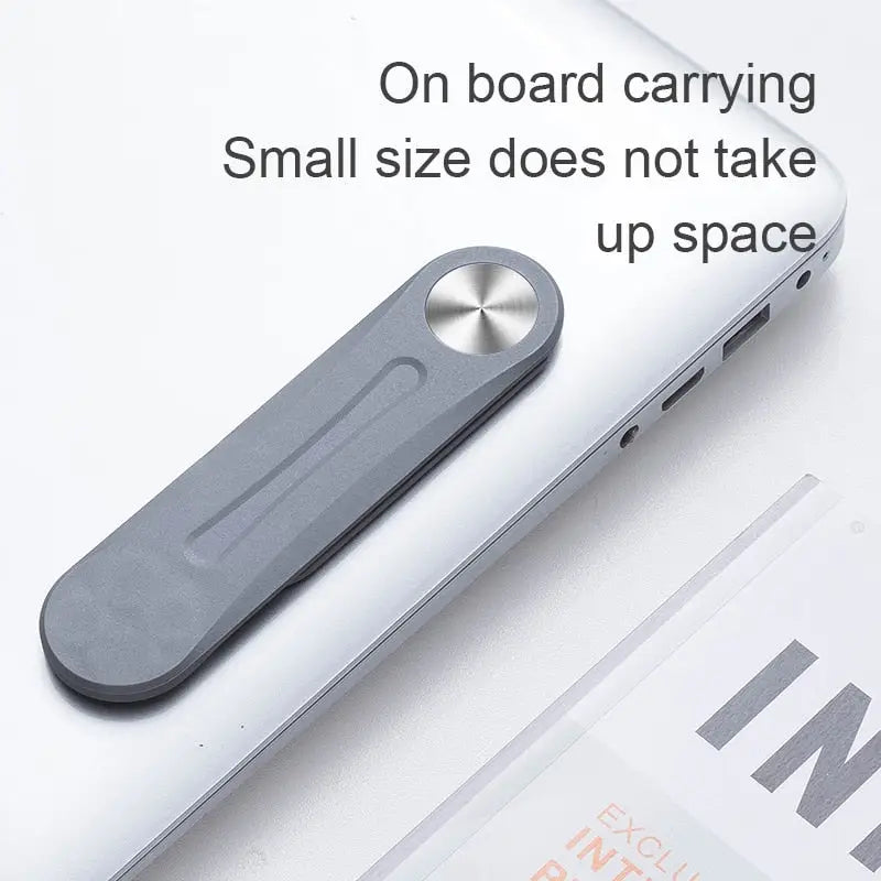 a white laptop with a black handle on top