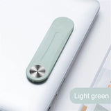 a white laptop with a green handle on top