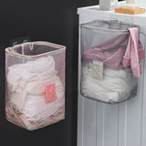 a white laundry basket with a pink laundry bag hanging on the wall