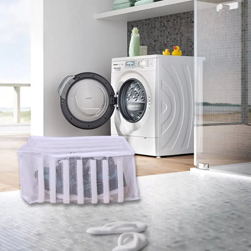 a white laundry room with a washing machine and a white towel