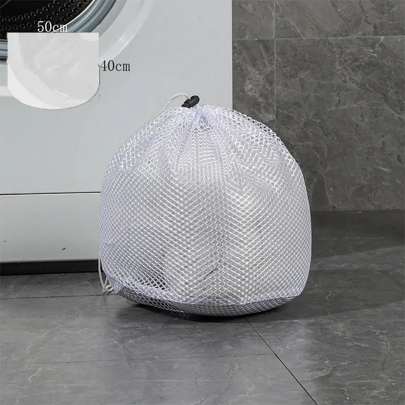 a laundry bag sitting on the floor next to a washing machine
