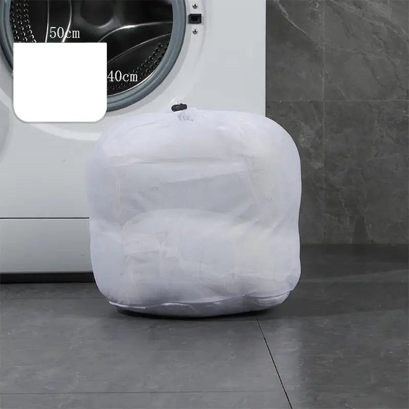a white washing machine sitting on top of a tiled floor