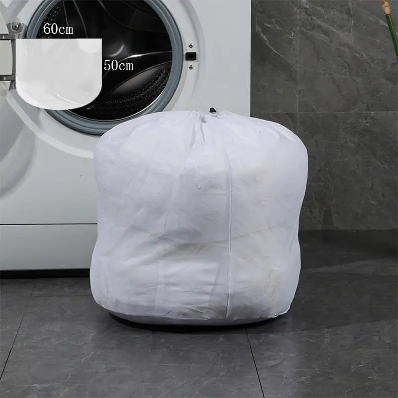 a white laundry bag sitting on top of a washing machine