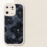 the back of a white iphone case with a black floral pattern