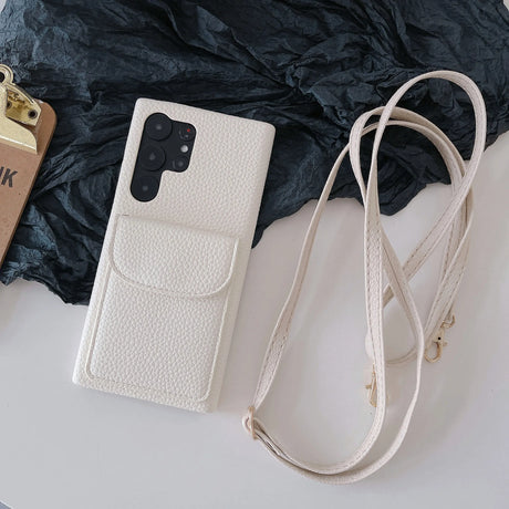 White leather phone case with a pocket and detachable strap.