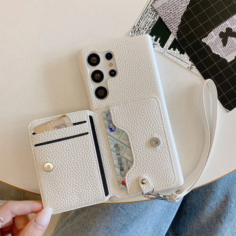 White leather wallet-style phone case with multiple card slots and a wrist strap.