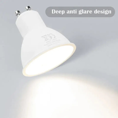 A white light bulb on a gray background