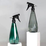two bottles with sprays on top of them