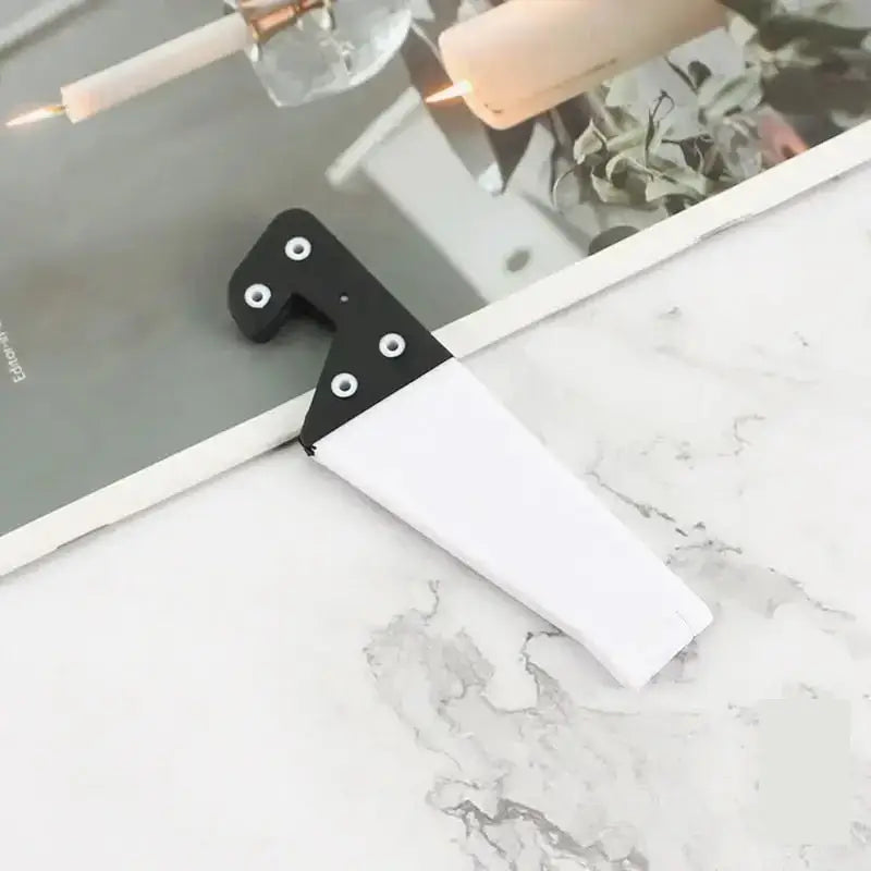 a white marble counter top with a black handle