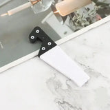 a white marble counter top with a black handle