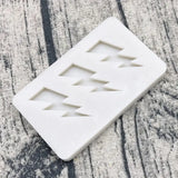 a white marble soap bar with three triangles