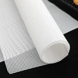 a roll of white mesh mesh fabric on a black background