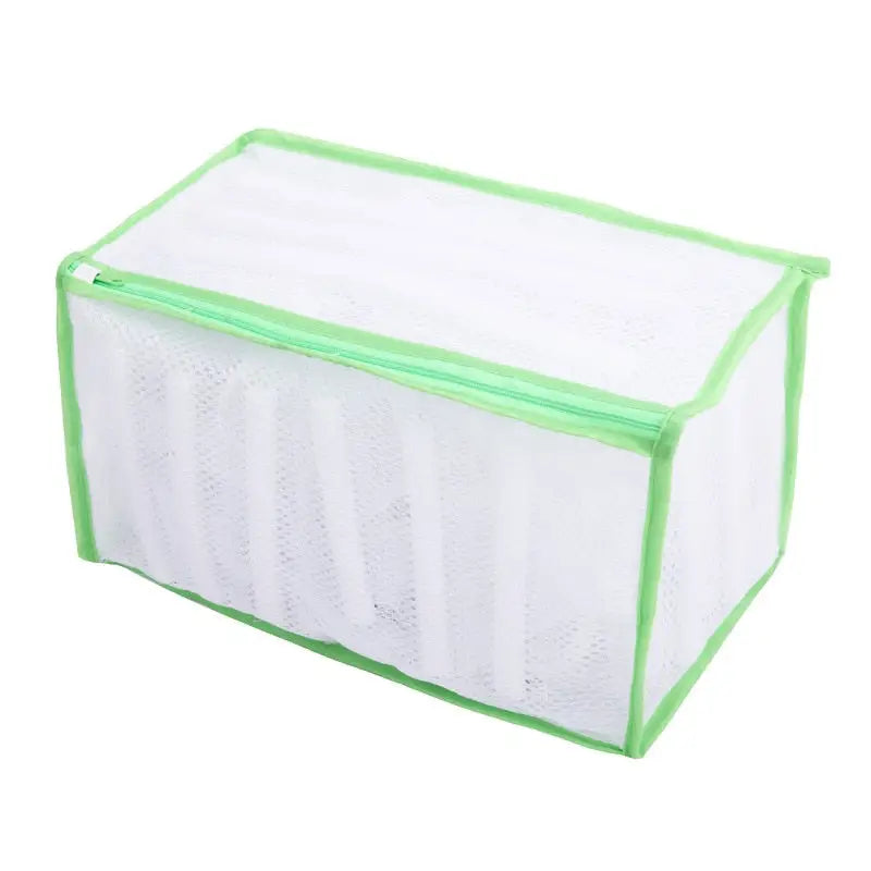 a white mesh bag with green trim