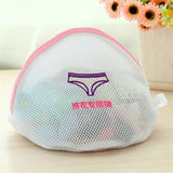 a white mesh bag with a pink handle