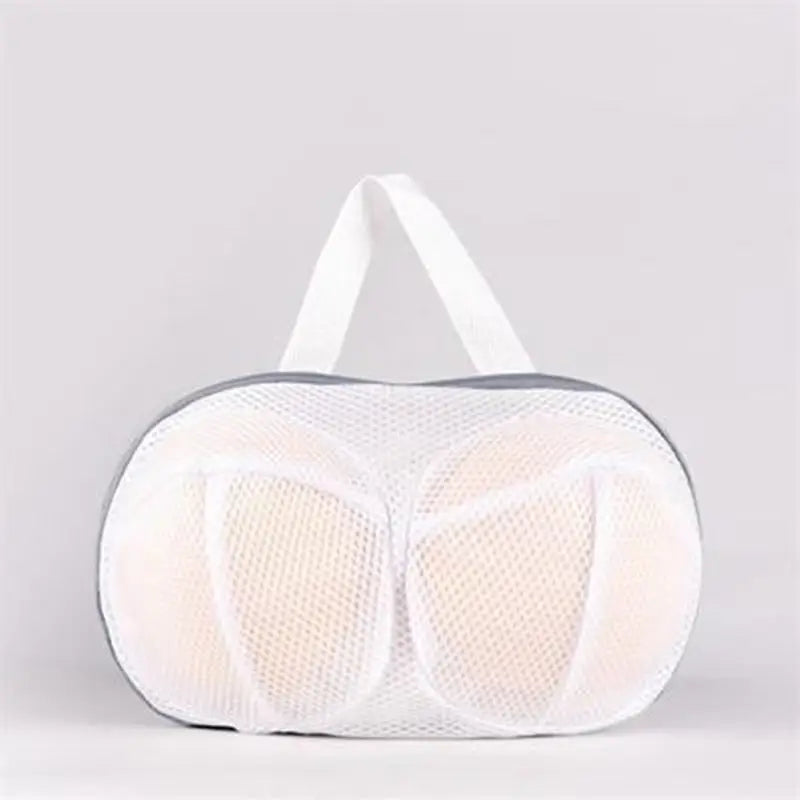 a close up of a white mesh bag with a white handle