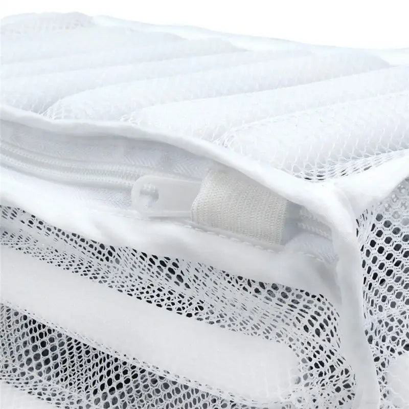 a white mesh bag with a zipper