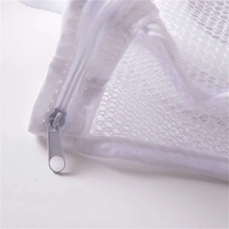 a white mesh bag with a zipper