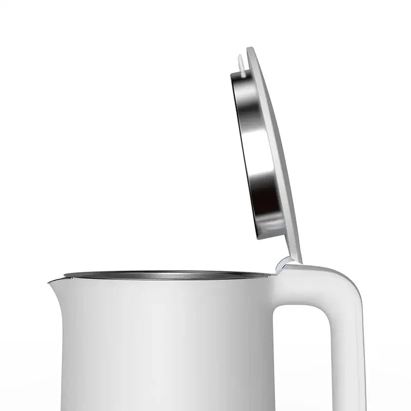 a white mug with a spoon in it