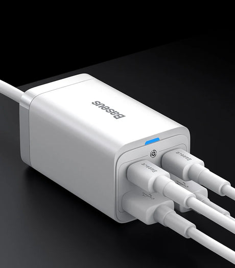 White multi-port USB charger with four connected cables.