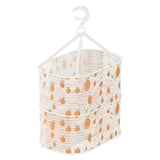 a white and orange fabric storage bag with oranges on it