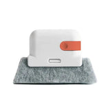 a white and orange cleaning pad with a red handle