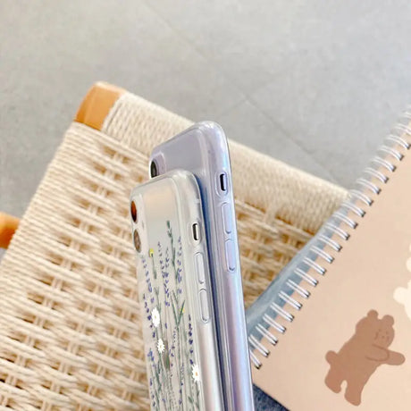 a white phone with a blue and white flower design on it