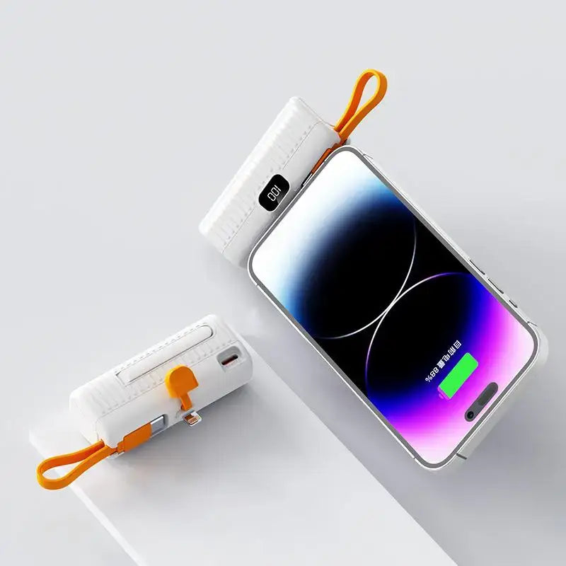 a white phone with a charging cable attached to it