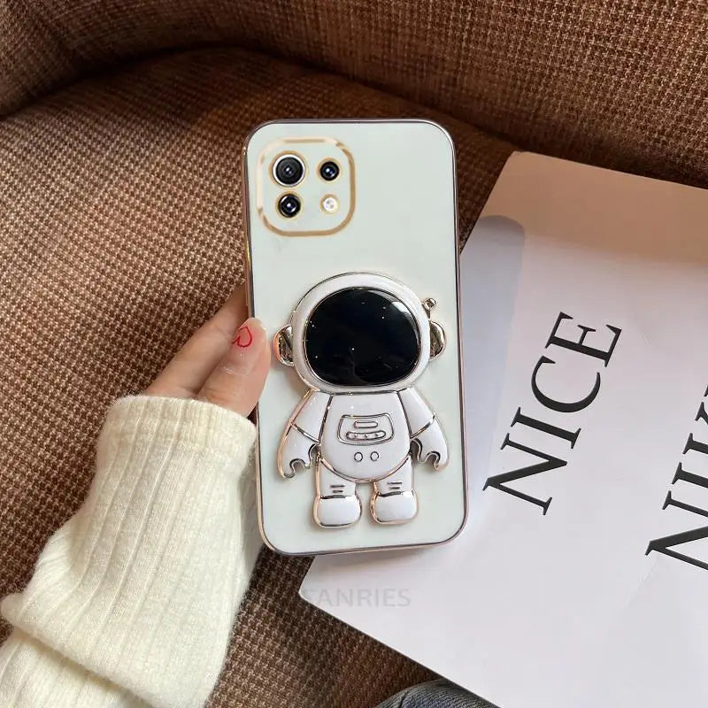 a white phone case with a small astronaut on it