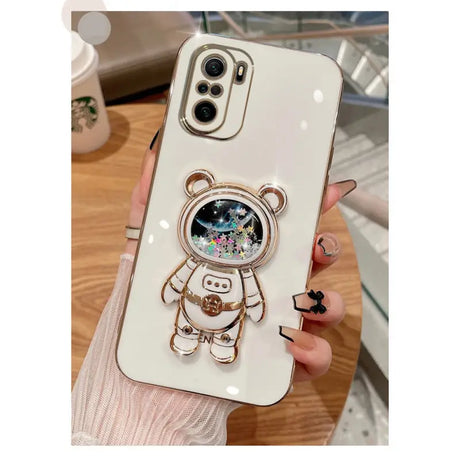 a white phone case with a bear and a flower