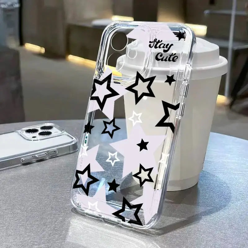 a white phone case with black stars on it