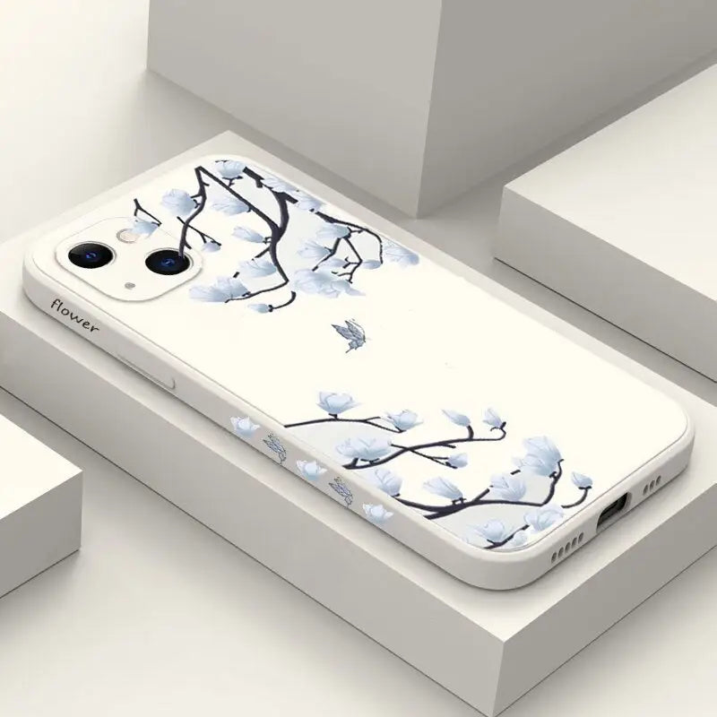 a white phone case with blue flowers on it