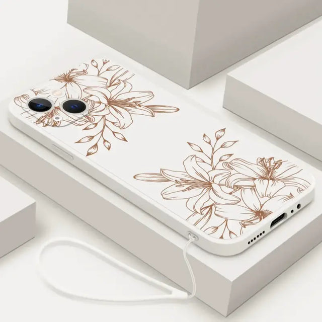 a white phone case with brown flowers on it