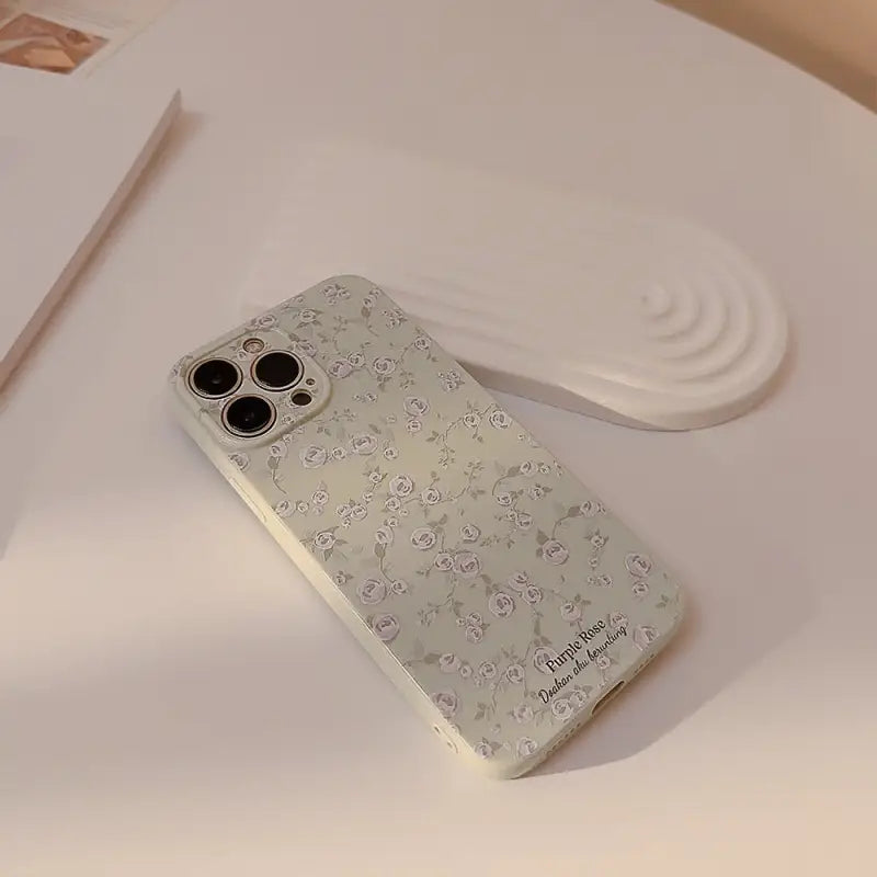 a white phone case with a flower pattern on it