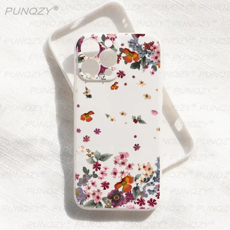 A white phone case with flowers and butterflies