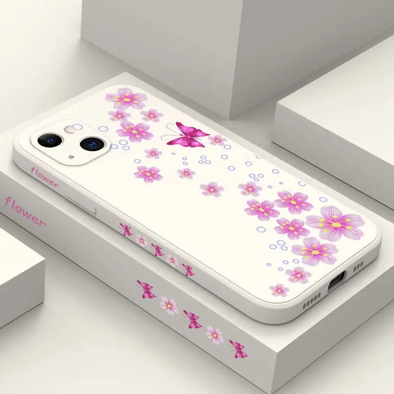 a white phone case with pink flowers on it