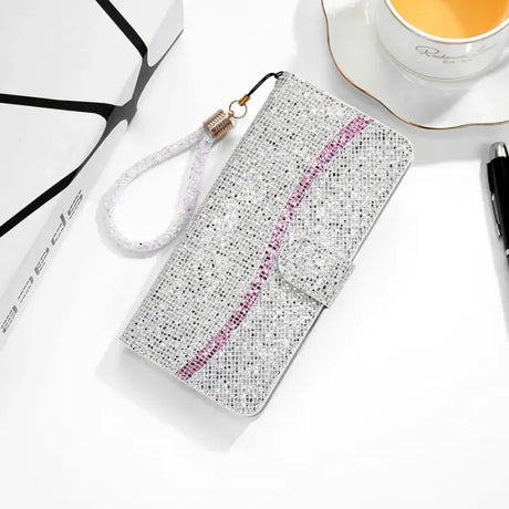 A white phone case with pink glitter on it