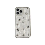 the back of a clear case with silver studs